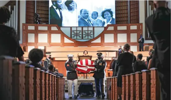  ?? ALYSSA POINTER/ATLANTA JOURNAL-CONSTITUTI­ON ?? The Honor Guard carries the body of Rep. John Lewis after the funeral service Thursday at Ebenezer Baptist Church in Atlanta.