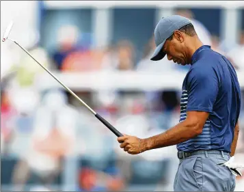  ?? WARREN LITTLE / GETTY IMAGES ?? Tiger Woods reacts Thursday on the 13th green during the first round of the 2018 U.S. Open in Southampto­n, New York. He endured a triple bogey and two doubles, and one four-putt from 35 feet.