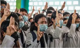  ?? Photograph: Anadolu Agency/Getty Images ?? Medical students hold up the three-finger salute at the funeral of Khant Nyar Hein in Yangon on Tuesday.