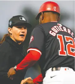  ?? RICH STORRY / GETTY IMAGES ?? Umpire Jen Pawol is greeted by Washington Nationals third base coach Ricky Gutierrez before a spring training game against the Houston Astros on Saturday in West
Palm Beach, Fla.