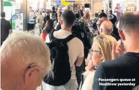  ??  ?? > Passengers queue at Heathrow yesterday