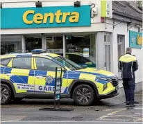  ?? ?? INJURIES Gardai at shop in village of Clarecastl­e, Co Clare