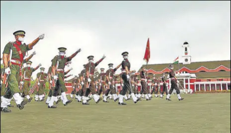  ?? PTI ?? MARCHING ON AMID COVID Newly-inducted officers march during the passing-out parade at Indian Military Academy in Dehradun on Saturday. A total of 423 officers passed out from the academy.