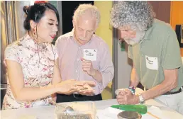  ??  ?? Alice Ye, left, demonstrat­es her technique for folding dumplings.