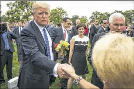 ?? AL DRAGO / THE NEW YORK TIMES ?? President Donald Trump greets people in Section 60 of Arlington National Cemetery on Memorial Day in Arlington, Va.
