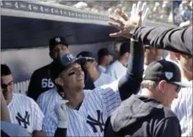  ?? LYNNE SLADKY - THE ASSOCIATED PRESS ?? New York Yankees’ Troy Tulowitzki celebrates in the dugout after hitting a solo home run in the first inning during a spring training game against the Toronto Blue Jays, Monday, in Tampa, Fla.