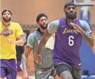  ?? JOE MURPHY/NBAE VIA GETTY IMAGES ?? LeBron James and the Lakers warm up during practice Monday in the NBA bubble.