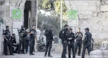  ??  ?? HOTSPOT: Israeli police at the Al-Aqsa Mosque compound near Lions’ Gate in Jerusalem’s Old City. Police yesterday removed the metal detectors placed there after two Israeli police officers were shot.