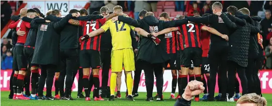  ?? GETTY IMAGES ?? I’ve got your back: Bournemout­h players and staff huddle after their win