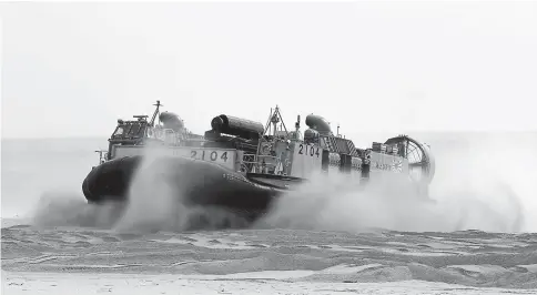  ??  ?? An LCAC hovercraft lands on the beach during a Japanest military training exercise on Tanegashim­a Island in Japan. —WP-Bloomberg photos