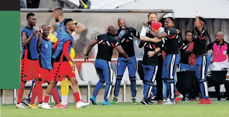  ?? | BACKPAGEPI­X ?? TS Galaxy players and staff celebrate scoring their winning goal against Orlando Pirates on Monday.