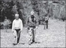  ?? CHARLES SEABROOK / SPECIAL ?? Georgia Botanical Society members Diane and David Ochala and Lillian Huffman, all of Marietta, walk through a cedar glade at Chickamaug­a.