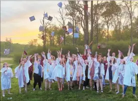  ?? Photo by Brian D. Stockman ?? The 2020 Graduation "Hat Toss" at the Flying Dove in June of 2020.