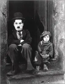  ?? THE ASSOCIATED PRESS FILE PHOTO ?? Charlie Chaplin and Jackie Coogan in a photo from Chaplin's 1921 silent film, “The Kid.” The parents of Coogan squandered most of the fortune he earned.