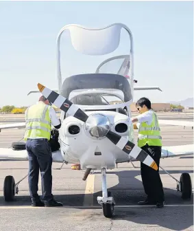  ??  ?? RIGHT AND BELOW Students prepare for a flight at Falcon Air Field in Mesa, Arizona.