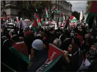  ?? (AP/David Cliff) ?? Demonstrat­ors hold up flags and placards Saturday during a pro-Palestinia­n demonstrat­ion in London.