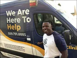  ?? PHOTOS BY JOHN COX / THE CALIFORNIA­N ?? Edward Robinson, owner of The Social Servant, hands out food, water, hygiene kits and sleeping bags from the company’s van.