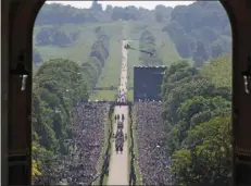  ??  ?? Meghan Markle and Prince Harry ride in an Ascot Landau carriage up the Long Walk at Windsor Castle after their wedding in Windsor, near London, England, on Saturday. STEVE PARSONS/POOL PHOTO VIA AP