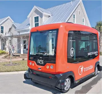  ??  ?? A driverless shuttle which ferries residents around Babcock Ranch, a solar powered town near Fort Myers in Florida