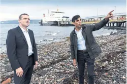  ?? ANDY BUCHANAN AFP/GETTY IMAGES ?? Britain’s Chancellor of the Exchequer Rishi Sunak, right, is seen with Douglas Ross, the new leader of the Scottish Conservati­ve Party at Wemyss Bay on the west coast of Scotland on Friday.