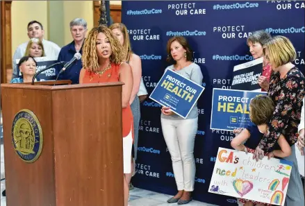  ?? HYOSUB SHIN / HYOSUB.SHIN@AJC.COM ?? U.S. Rep. Lucy McBath speaks as Vivienne Sacks (right), 5, holds a sign at a “Protect Our Care Georgia Health Care Emergency” news conference last month at the Georgia State Capitol. McBath headlined a rally extolling the Affordable Care Act’s protection­s for patients. But the freshman Democrat representi­ng a swath of Atlanta’s northern suburbs did not mention the law’s name from the podium even once.