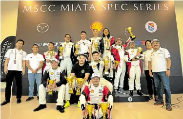  ?? ?? Trophy winners of the final race on the podium with Mazda Motor Corp. officials and Mazda PH president Steven Tan.