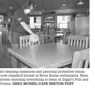  ?? GREG MCNEIL/CAPE BRETON POST ?? Enhanced cleaning measures and personal protective equipment is now standard format at Nova Scotia restaurant­s. Ryan Wall is shown ensuring everything is clean at Ziggy’s Pub and Grill on Friday.