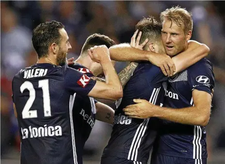  ?? Photo: Daniel Pockett ?? GOAL: Ola Toivonen is congratula­ted by Victory teammates after scoring against United.