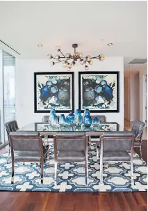  ??  ?? Comfort is just as important as beauty when choosing dining room seating, says Fenimore, founder of the design firm Studio Ten 25, who chose sleek but softly padded chairs for the dining room shown here.