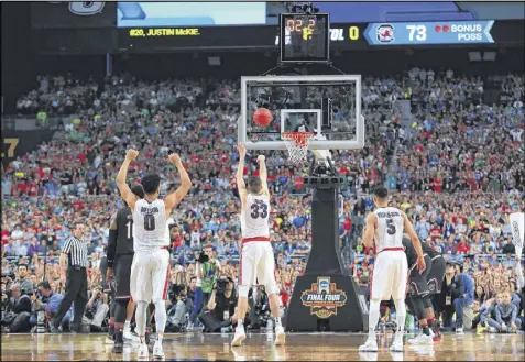  ?? TOM PENNINGTON / GETTY IMAGES ?? Killian Tillie shoots a late free throw in the second half Saturday to help the Bulldogs put away a stubborn Gamecocks team. Gonzaga, which is in its first Final Four, advances to Monday’s title game.