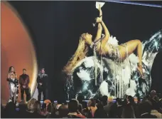  ?? AP PHOTO/CHRIS PIZZELLO ?? Beyonce (left) accepts the award for best dance/ electronic music album for “Renaissanc­e” at the 65th annual Grammy Awards on Sunday in Los Angeles. James Corden looks on from left.