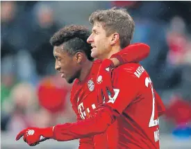  ??  ?? Bayern’s Kingsley Coman, left, celebrates with Thomas Mueller.