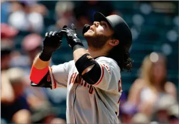  ?? AP PHOTO BY DAVID ZALUBOWSKI ?? San Francisco Giants’ Brandon Crawford gestures as he crosses home plate after hitting a two-run home run off Colorado Rockies relief pitcher Jesus Tinoco in the sixth inning of a baseball game Monday, July 15, 2019, in Denver.