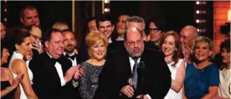  ??  ?? Scott Rudin, center, and the cast of "Hello, Dolly!" accept the award for best revival of a musical.