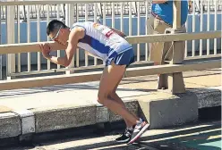  ??  ?? NOTHING LEFT TO GIVE: The marathon drama unfolds as exhausted race leader Callum Hawkins first stumbles and falls to the ground before the Scot runner receives attention and is taken away by ambulance to hospital