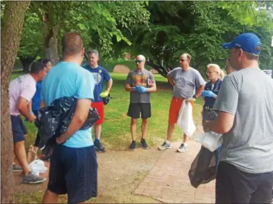  ?? BILL RETTEW JR. – DIGITAL FIRST MEDIA ?? West Chester Area School District staffers get ready to run and pick up litter.