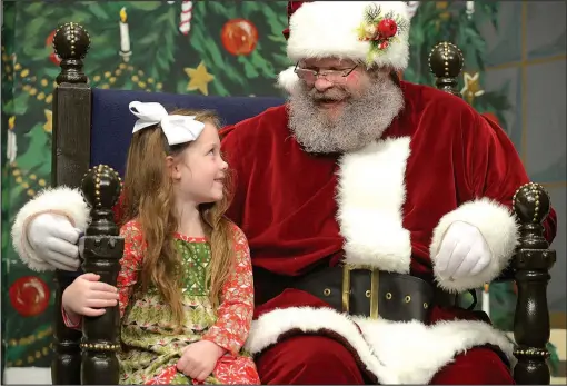  ?? File Photo/ANDY SHUPE ?? Braylin Smith of Bentonvill­e smiles as she tells Santa Claus what she wants for Christmas during the annual Breakfast With Santa at the Arts Center of the Ozarks in Springdale. Santa is everywhere this season, with visits to the Northwest Arkansas...