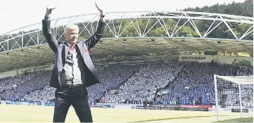  ?? — AFP photo ?? Arsenal manager Arsene Wenger waves to fans before the English Premier League match against Huddersfie­ld Town at the John Smith’s stadium in Huddersfie­ld, northern England.