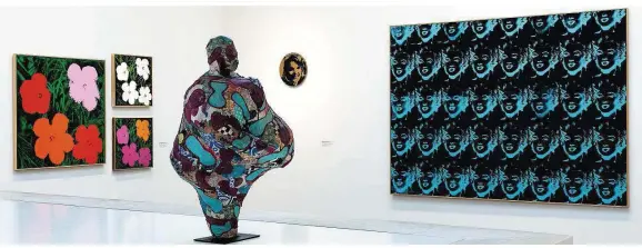  ??  ?? Ein erster Blick in die Ausstellun­g „Wow!“: Im Vordergrun­d eine mit Textilien überzogene Skulptur von Niki de Saint Phalle, an den Wänden mehrere Arbeiten von Andy Warhol