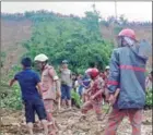  ?? STRINGER/AFP ?? Bangladesh­i firefighte­rs and volunteers are watched by bystanders as they search for bodies after a landslide in Rangamati on Tuesday.