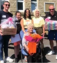  ??  ?? Pat Dyson receiving gifts at her retirement party after 21 years at Peel Park Primary School.