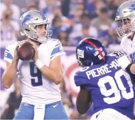  ?? | JULIO CORTEZ/ AP ?? Lions quarterbac­k Matthew Stafford completed 15 of 21 passes for 122 yards and two touchdowns Monday night against the Giants, who fell to 0- 2.