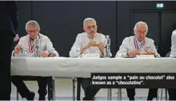  ?? ?? Judges sample a “pain au chocolat” also known as a “chocolatin­e”.