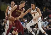  ?? Aaron Ontiveroz / The Denver Post ?? The Nuggets’ Michael Porter Jr., right, tries to guard the Cavaliers’ Lauri Markkanen on Monday at Ball Arena in Denver.