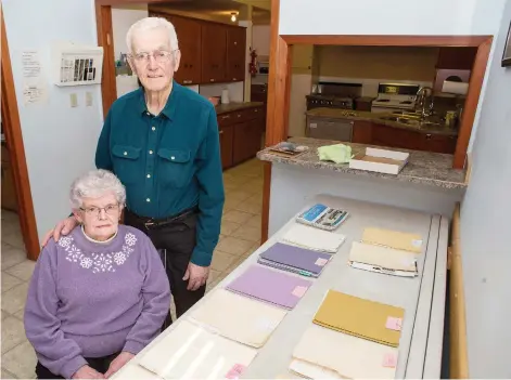  ?? KAYLE NEIS ?? Tina and Ben Bueckert stand next to 14 files outlining the fraud that drained them of the majority of their life savings. On Jan. 31, David Matthew Adrian pleaded guilty to fraud over $5,000 and was sentenced to five years in prison.
