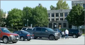  ?? NWA Democrat-Gazette/ANDY SHUPE ?? Visitors walk from their cars Saturday after parking in Lot 71 on the University of Arkansas campus in Fayettevil­le.