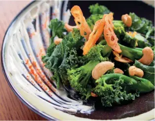  ??  ?? VIRTUOUS PLATES A wok-charred broccoli and broccolini salad at Empress includes crisp kale leaves, cashew nuts and slices of lotus root.