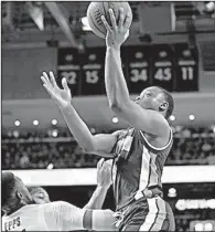  ?? AP/ALBERT CESARE ?? Auburn guard Mustapha Heron (right) shoots over LSU forward Aaron Epps during the first half Saturday in Auburn, Ala. Heron had 21 points and 9 rebounds as Auburn won 95-70.