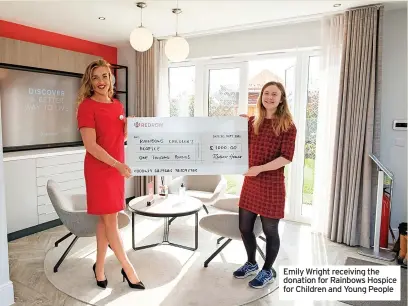  ?? ?? Emily Wright receiving the donation for Rainbows Hospice for Children and Young People