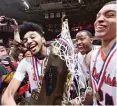  ?? FRED ZWICKY/ JOURNAL STAR VIA AP ?? Whitney Young boys basketball players celebrate after winning the Class 4A state title earlier this month.
|